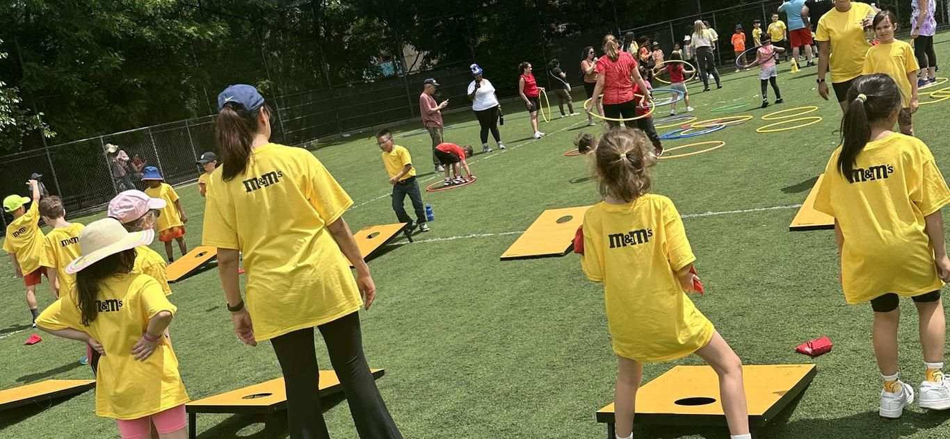Students in yellow shirts playing games on the field