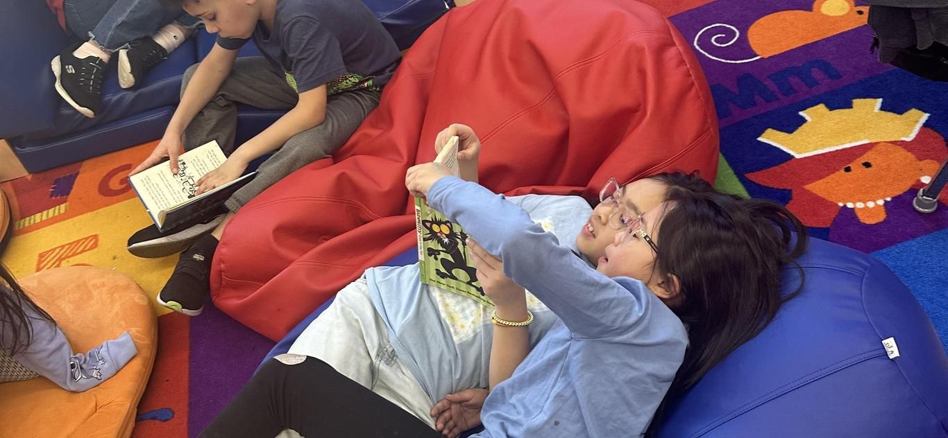 Students reading on beanbags in the school library