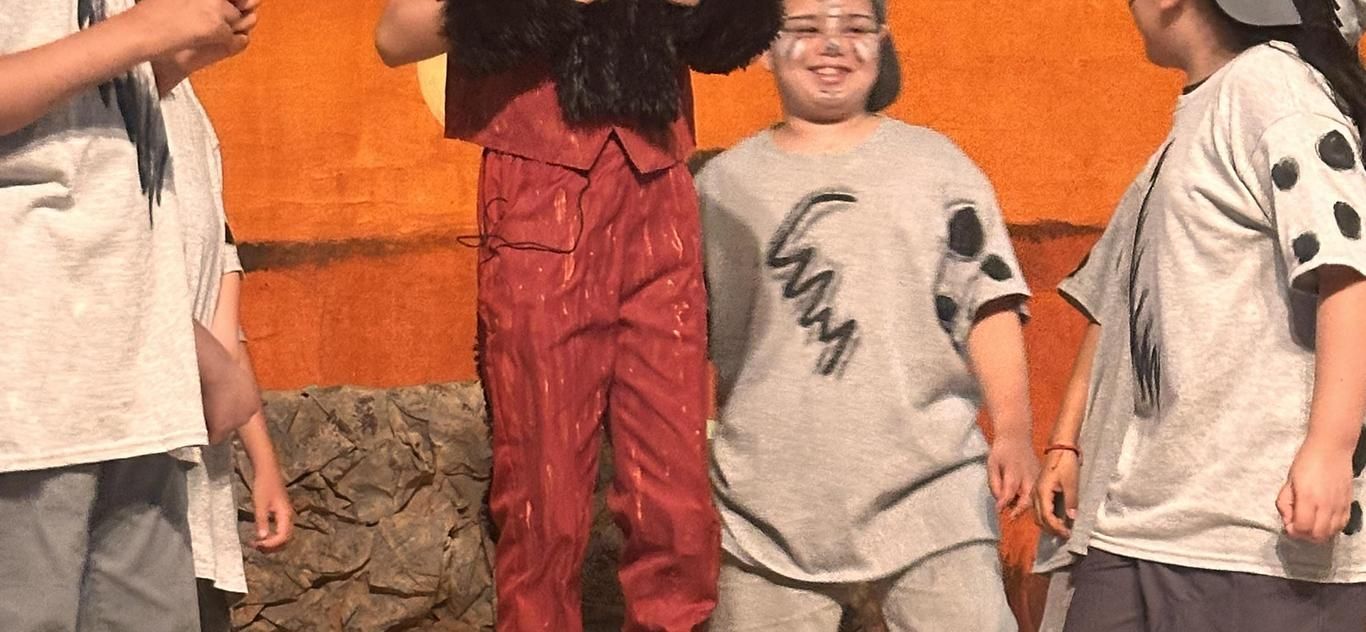 Students in costume performing The Lion King