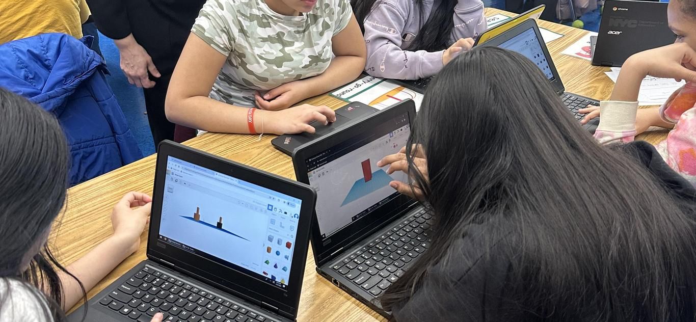 Students working on laptops in the STEM lab